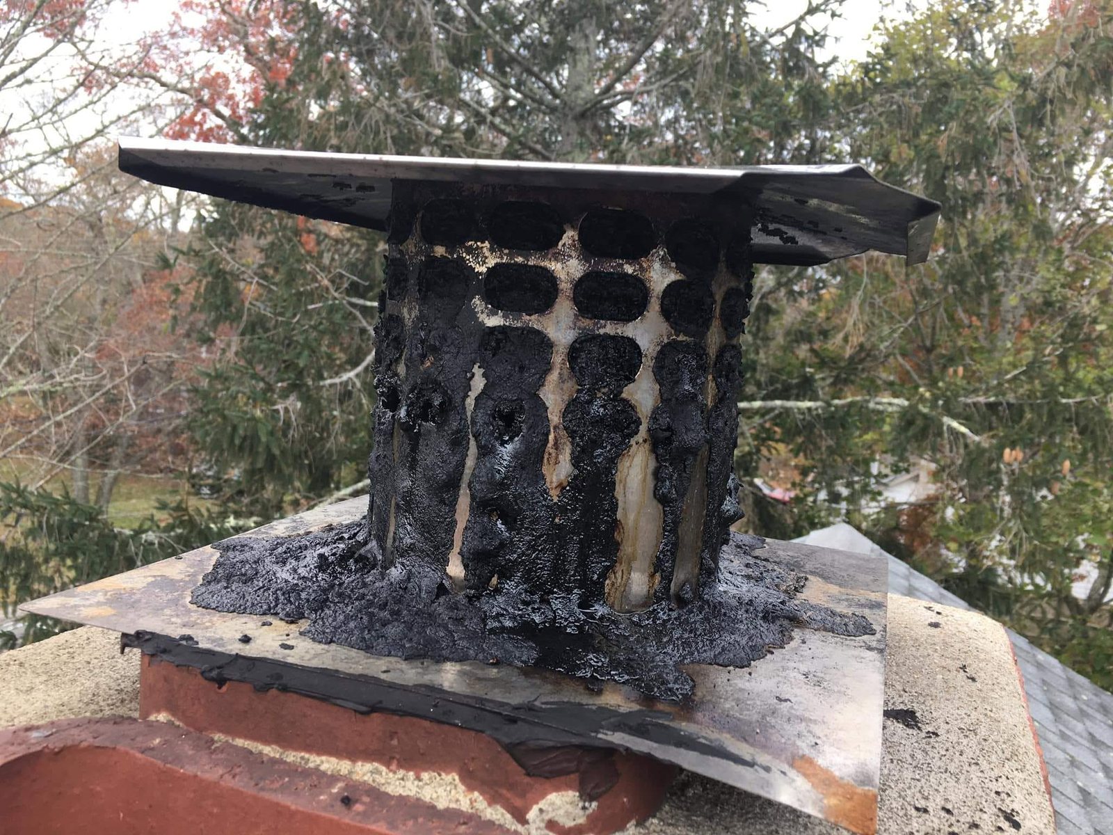 Heavy creosote buildup burned onto a chimney cap